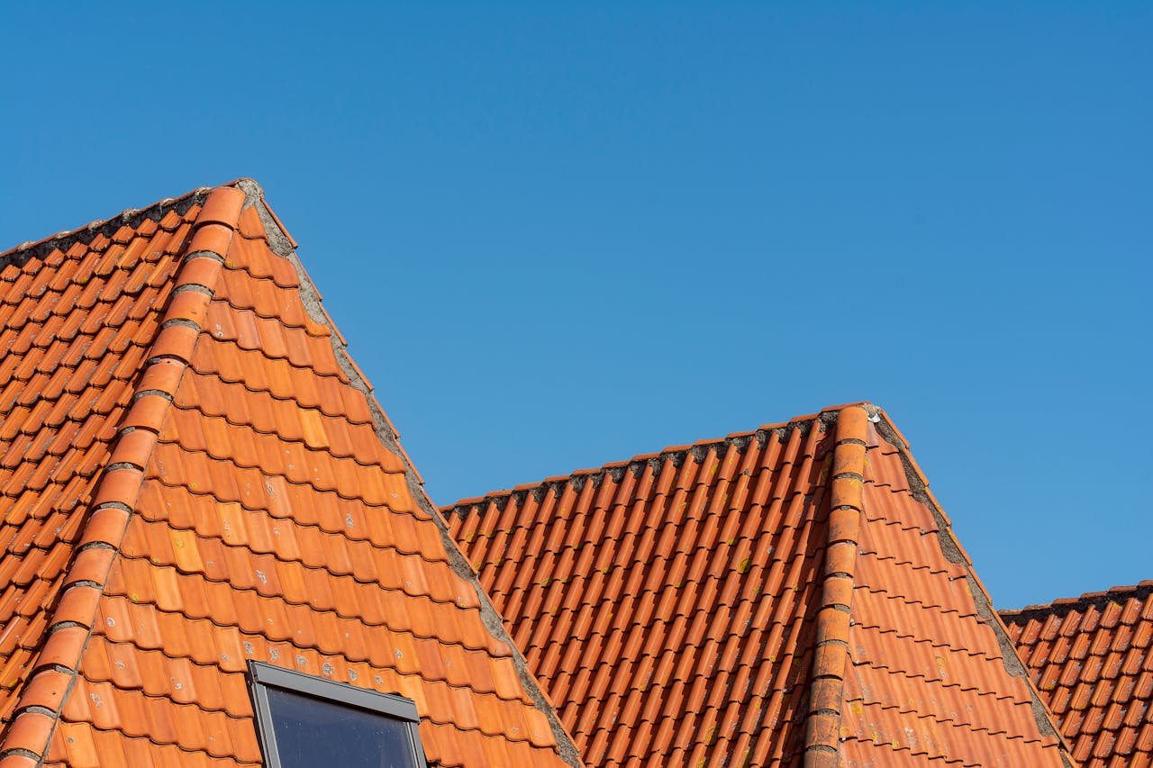 Crafting Captivating Headlines: Your awesome post title goes here Close-up of red tiled roofs under a clear blue sky, showcasing architectural design.